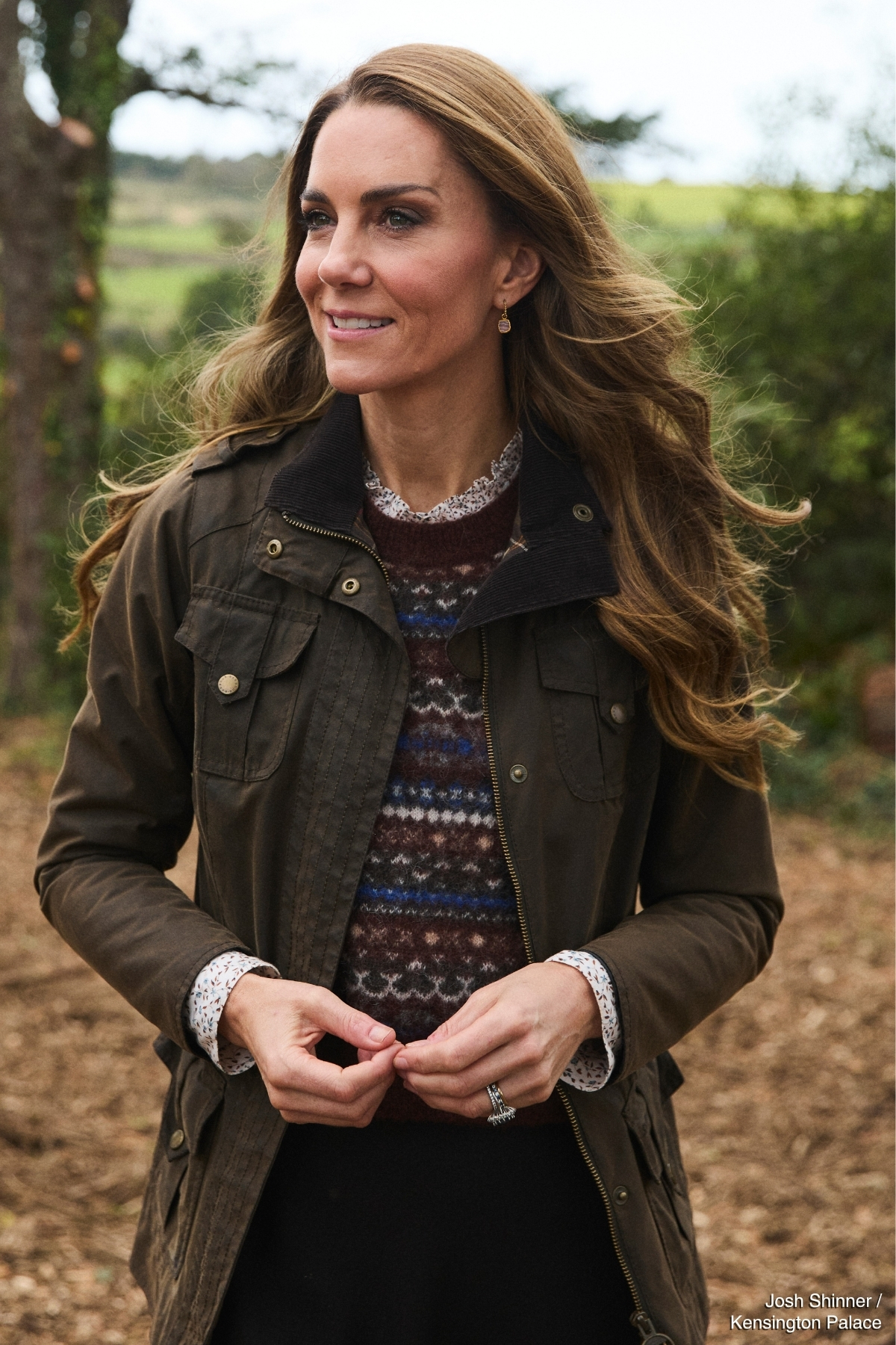 The Princess of Wales in country-style layers against a woodland backdrop in Cornwall