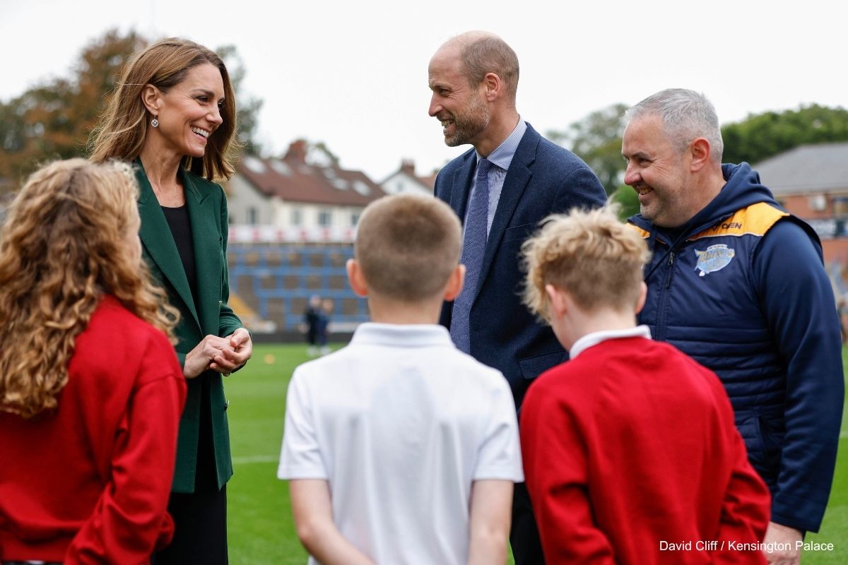 Kate smiles during a conversation with young rugby players