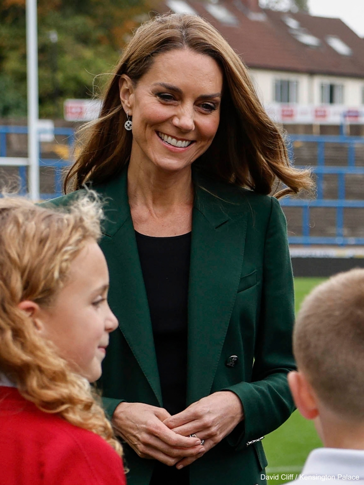 Kate Middleton in her green Ralph Lauren blazer meeting young rugby players at Headingley
