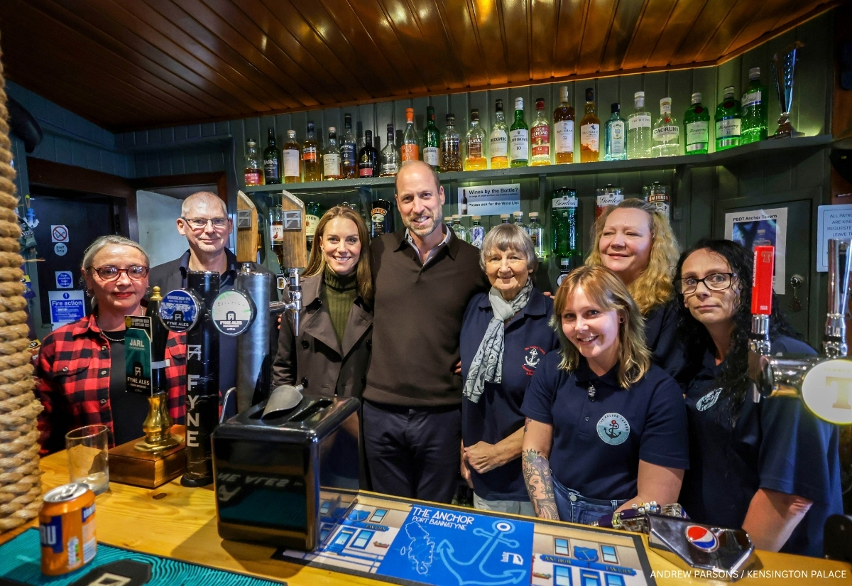 Prince William and Kate Middleton with community members behind the bar at the Anchor Tavern and Hub