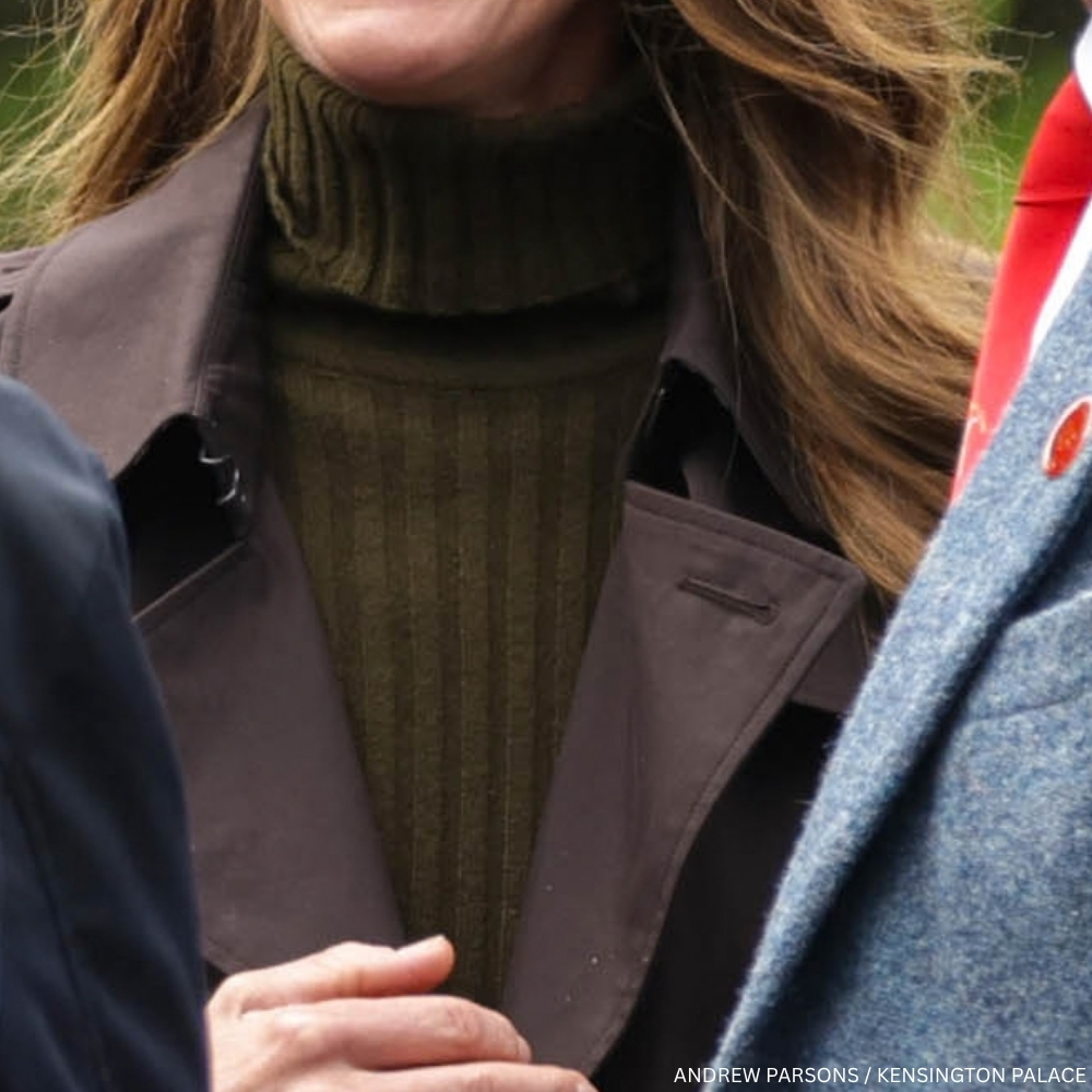 Close-up of Kate Middleton wearing an olive-green ribbed roll-neck sweater beneath her brown Burberry coat