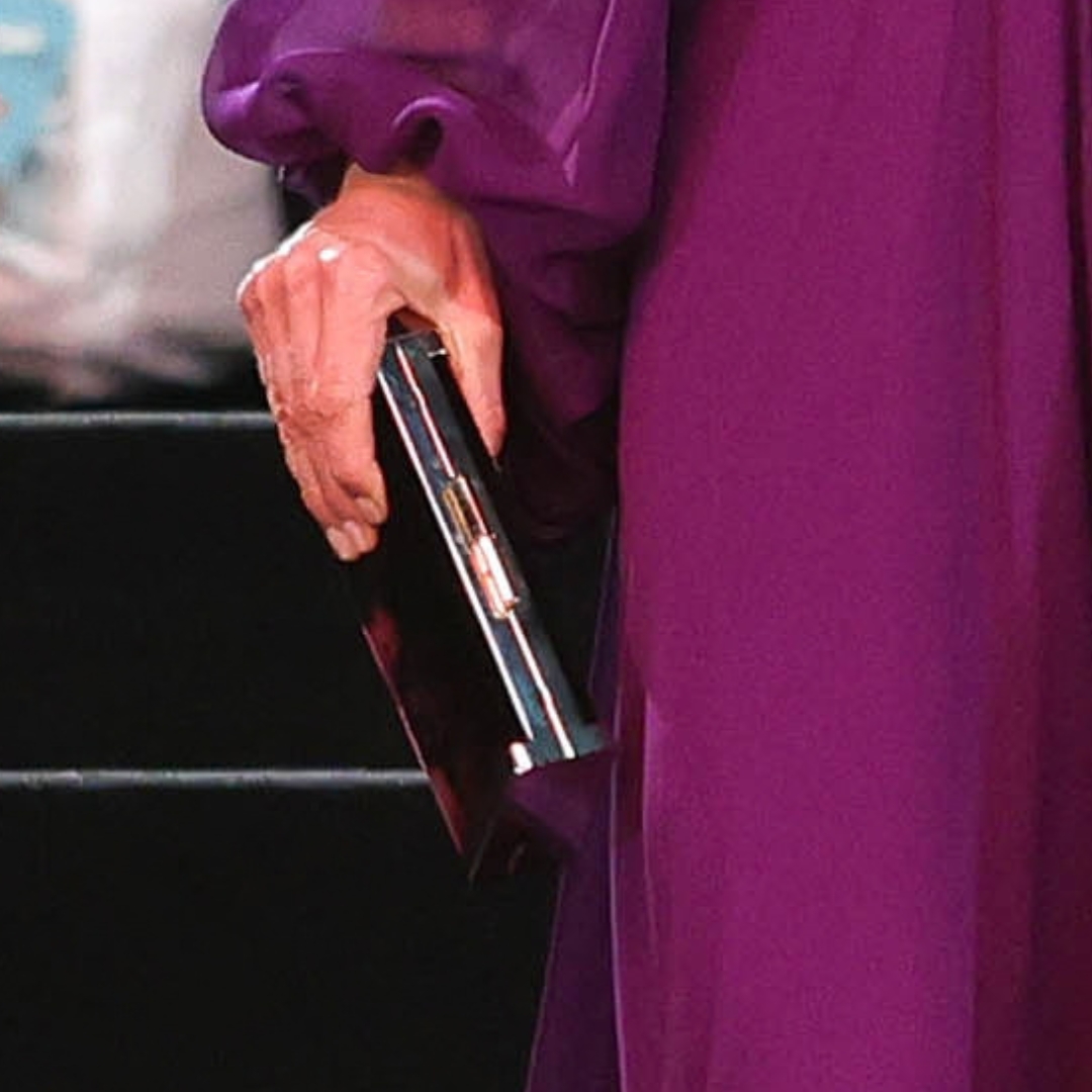 Kate Middleton carrying her burgundy Jimmy Choo J Box velvet clutch at the Digger premiere
