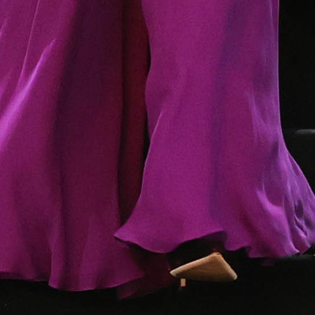 Close-up of Kate Middleton’s burgundy velvet heel beneath her purple gown