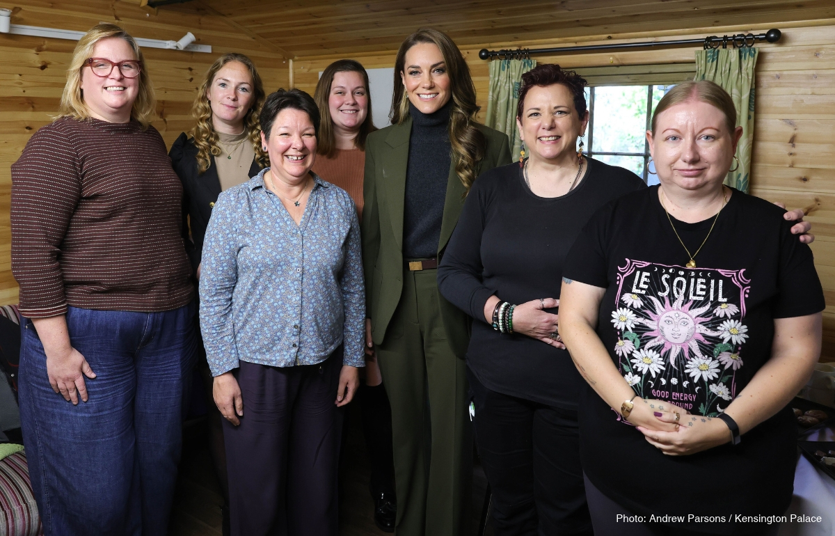 Kate Middleton posing with a group during her visit to The Treehouse hospice