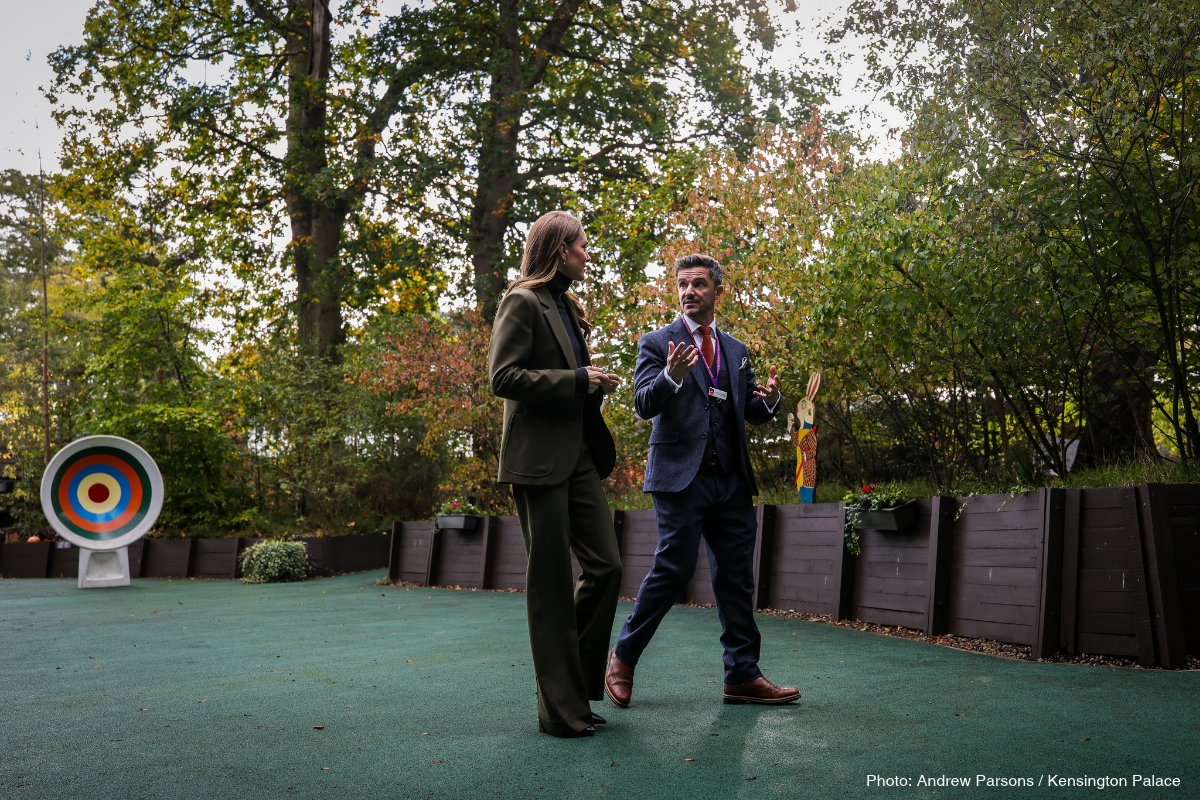 Kate Middleton walking through the hospice grounds in her green Victoria Beckham suit
