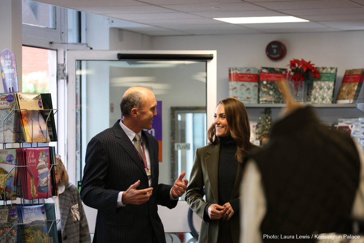 Kate Middleton speaking with a member of staff inside the EACH charity shop at Café 98