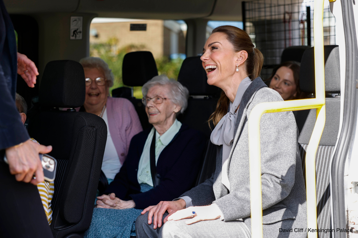 Kate Middleton smiling with passengers aboard the West Sussex minibus
