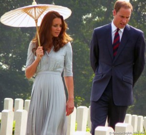 Kate holds a parasol while touring the graves at Kranji war cemetery