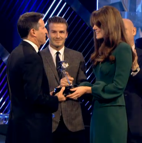 Kate in teal dress presenting award