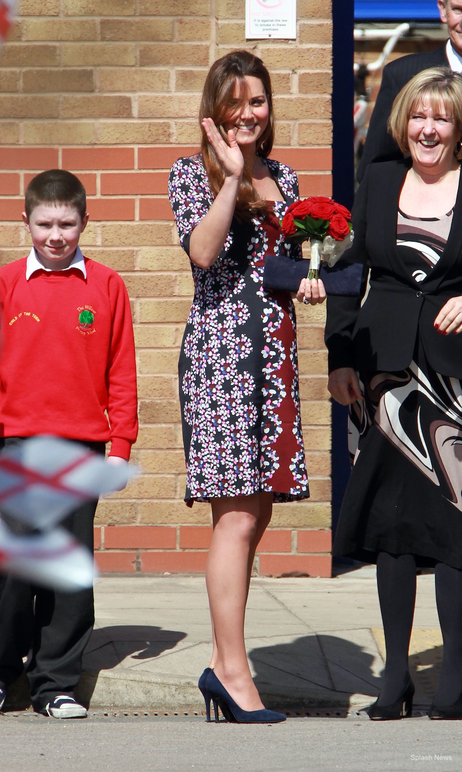 Pregnant Kate Middleton visits Manchester in 2013.  The Duchess wears an Erdem dress