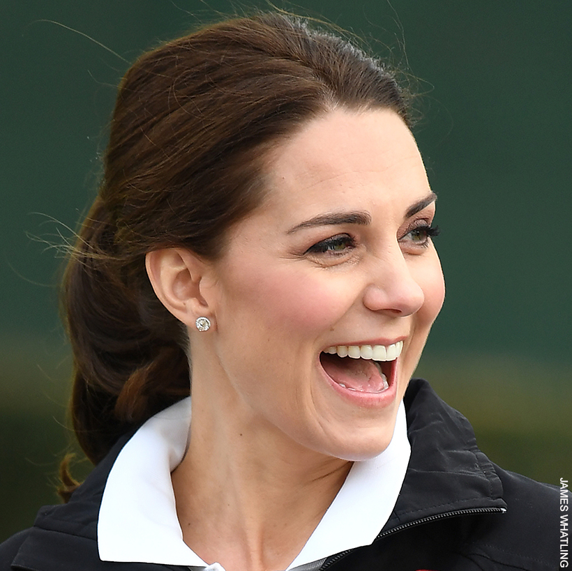 Smiling Kate Middleton dressed casually in sportswear and hr hair tied up, wearing the Kiki McDonough Grace diamond stud earrings
