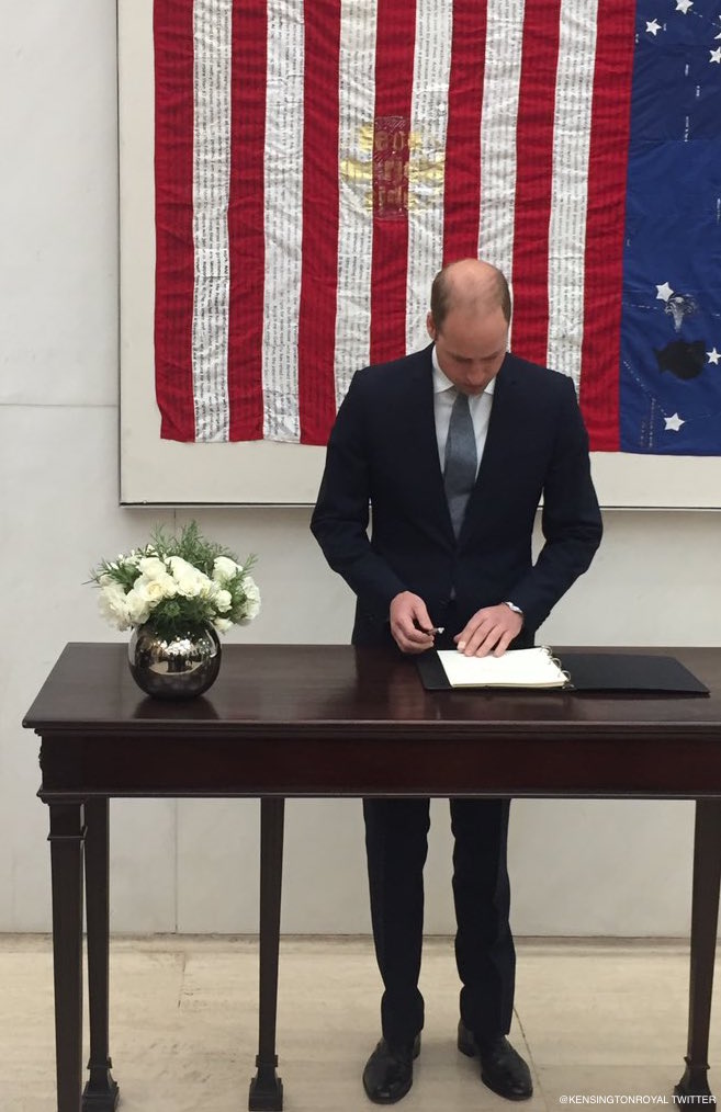 Prince William signing the book of condolences under the Kaleidoscope flag