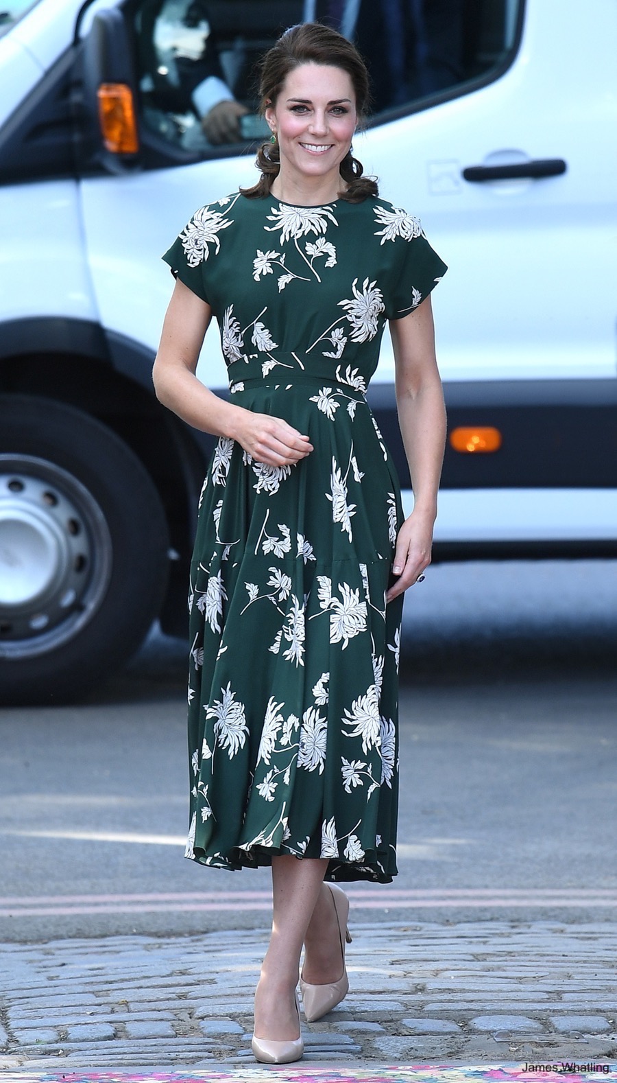 Kate Middleton at the Chelsea Flower Show wearing a green floral dress and nude heels.