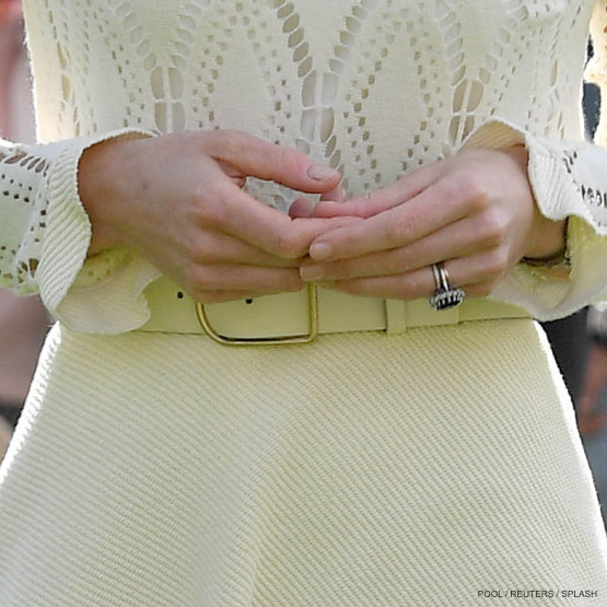 Britain's Catherine, Duchess of Cambridge attends a tea party at Buckingham Palace in London wearing an Acne Studios belt