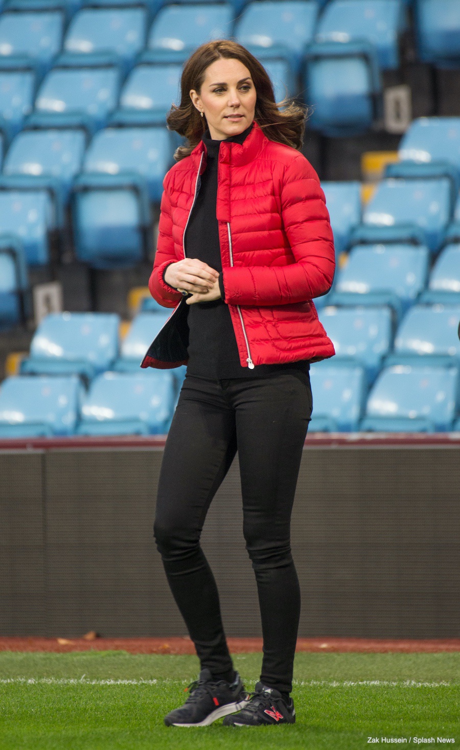 Kate Middleton, dressed in a black and red outfit, wearing the New Balance x Sweaty Betty Vazee trainers. 