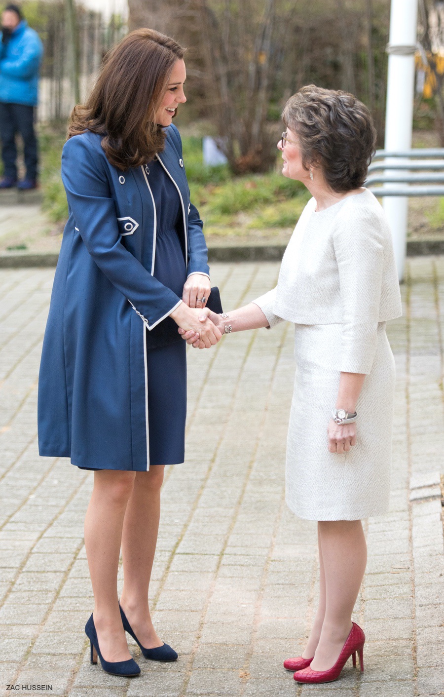 Pregnant Kate wearing a blue dress and jacket at the RCOG today