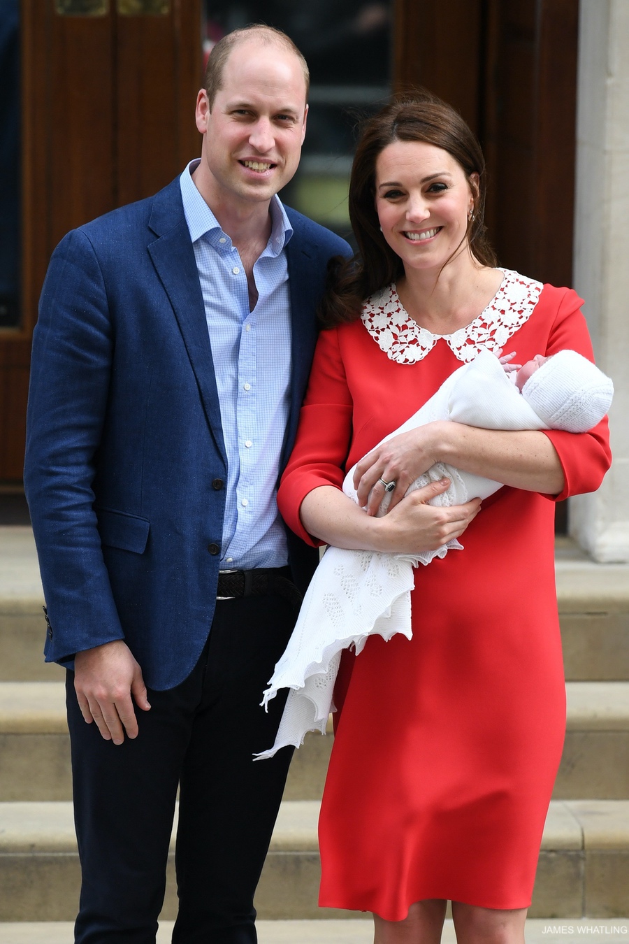 Kate Middleton and Prince William with their newborn baby boy, the Princess wears a bright red dress by Jenny Packham