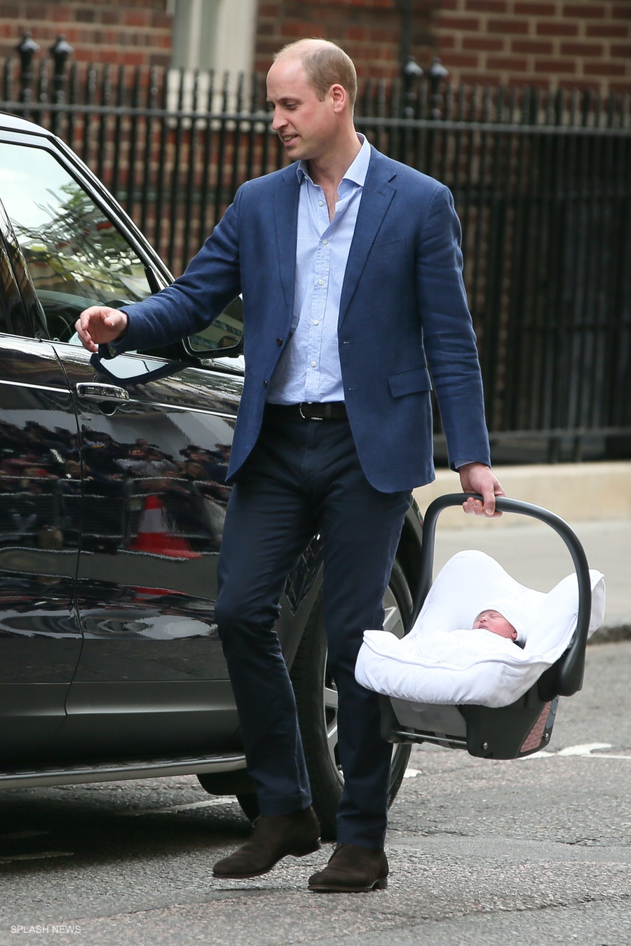 Prince William putting the new baby in the car