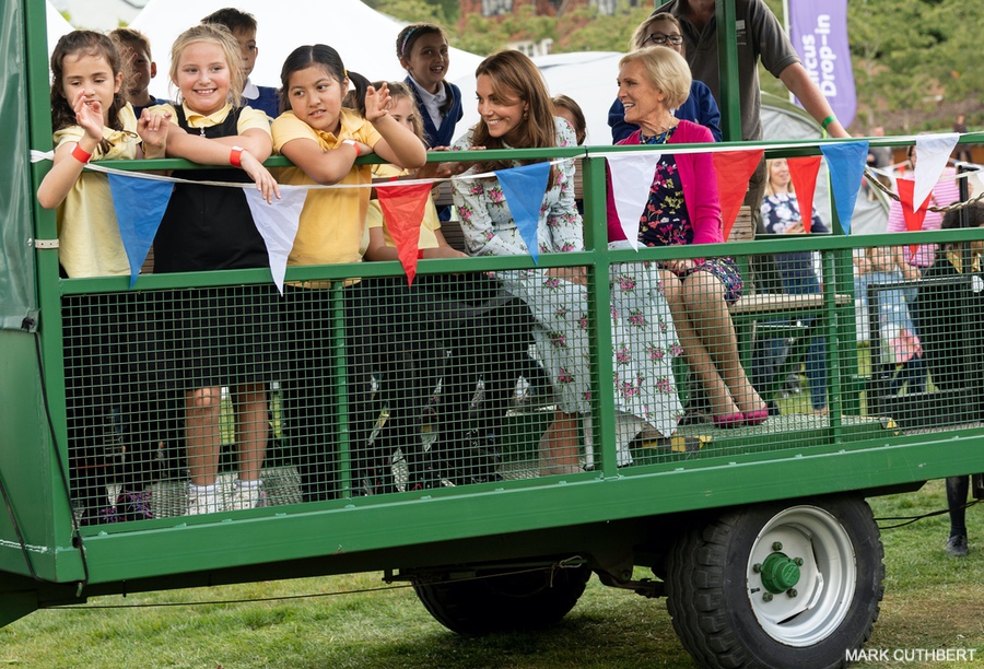 The Duchess of Cambridge riding on a tractor trailer