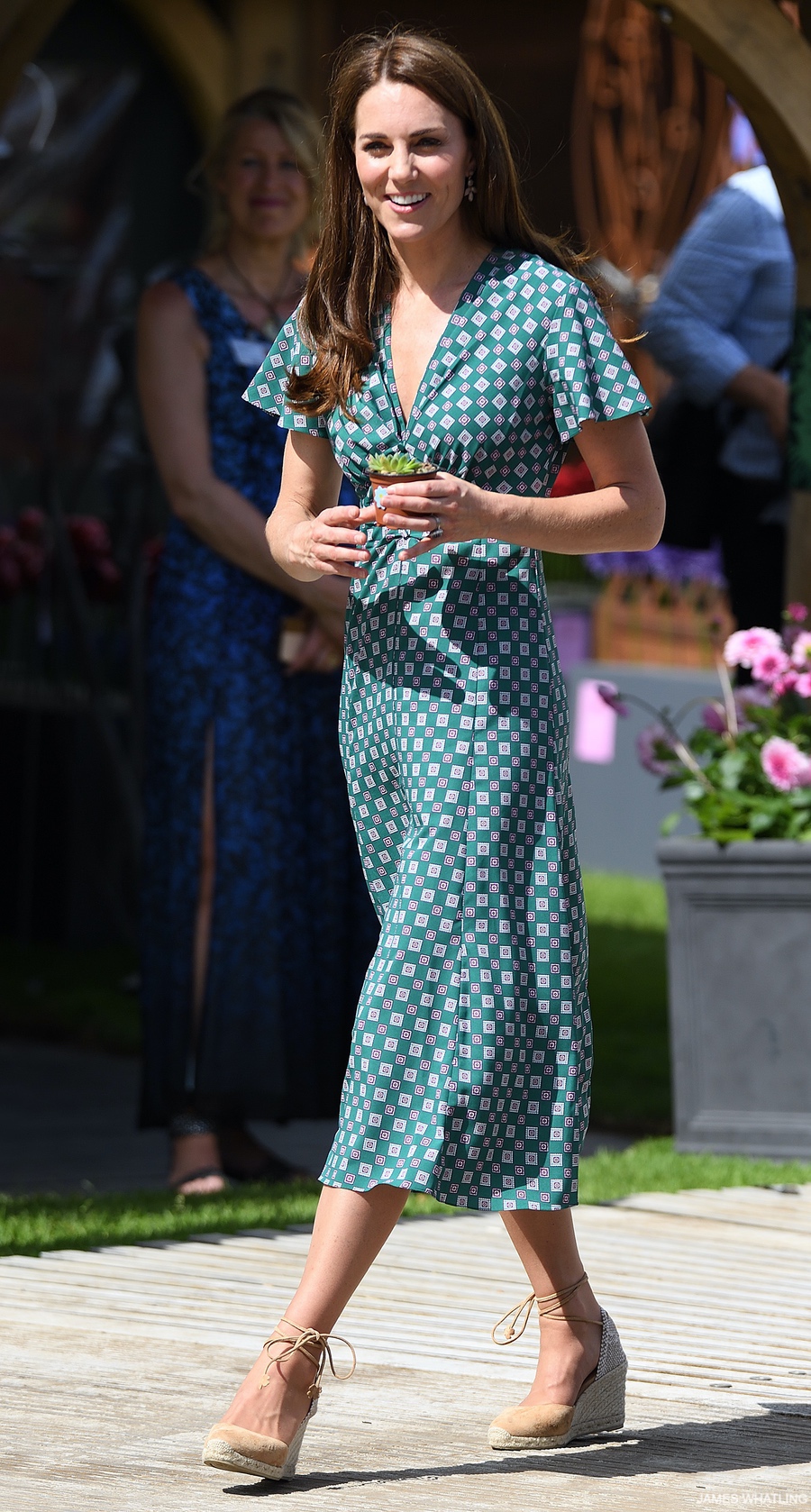 Kate Middleton wears a green midi length dress by Sandro during the garden picnic at Hampton Court Flower Show