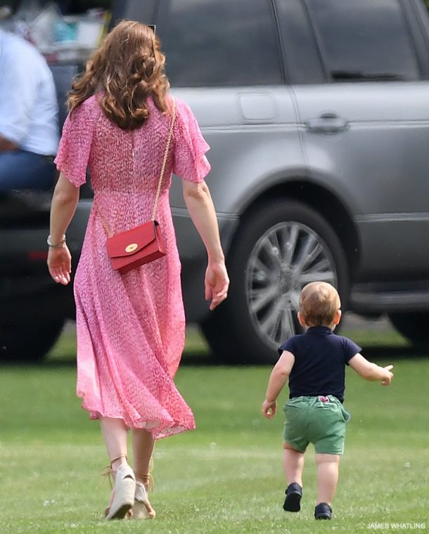 Kate carries a red bag at the polo match, while Prince Louis runs after her