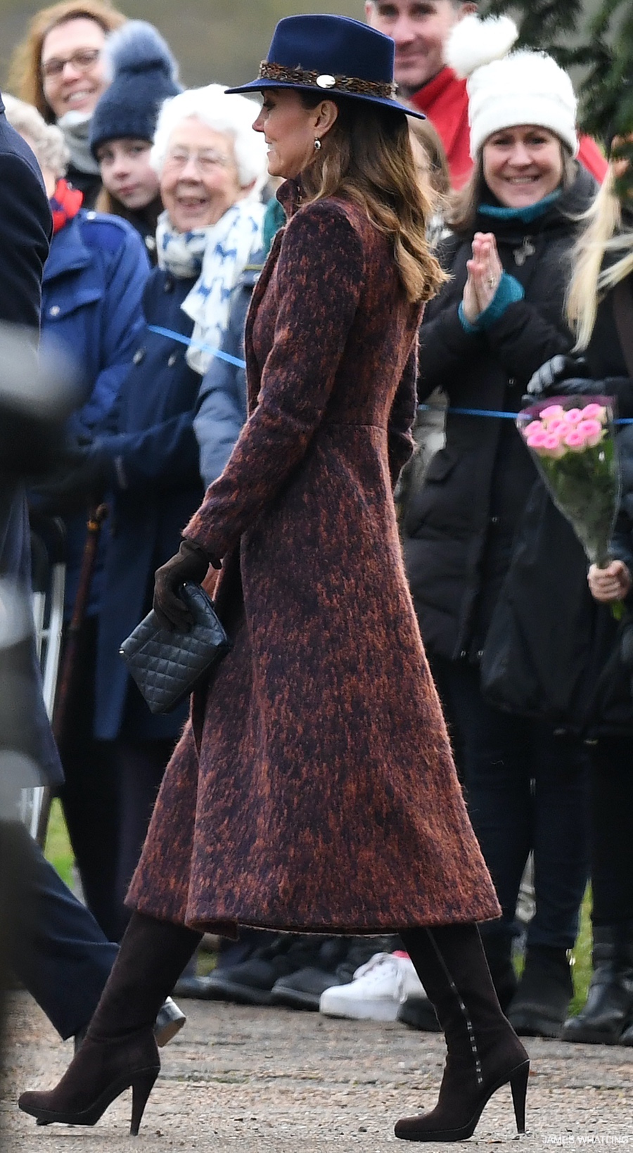 Kate Middleton walking, she wears a pair of brown suede boots.  They're the Stuart Weitzman Zipkin style.