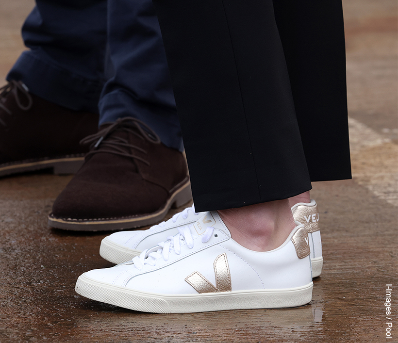 Kate Middleton's white sneakers. The gold V logo is clear to see on the side of the sneakers. 