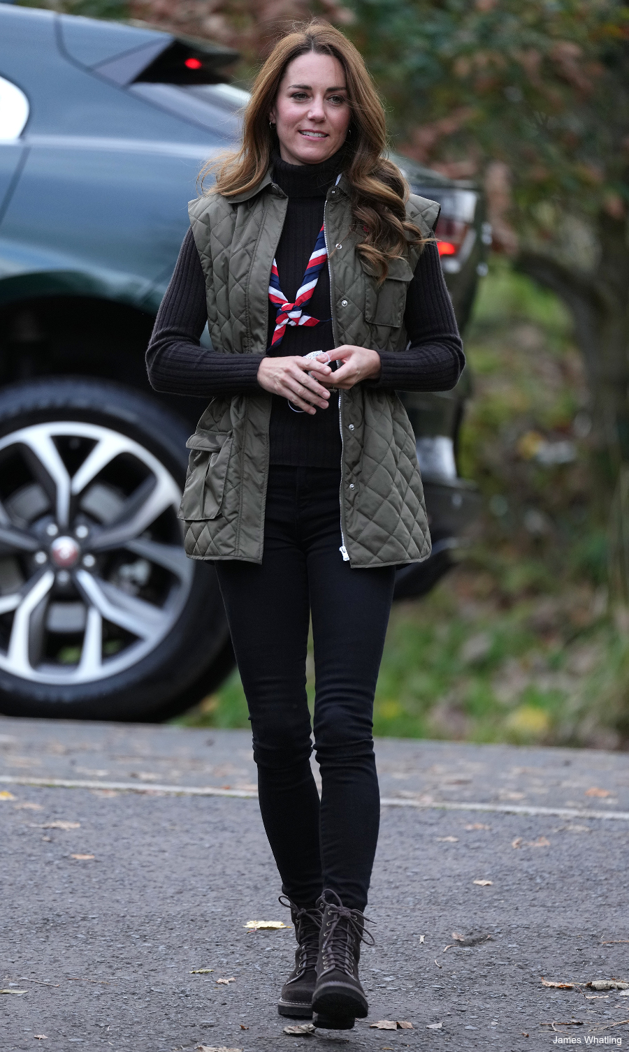 Kate Middleton dressed in a casual outfit during a visit with the Scouts. She paired the combat boots with a green gilet.