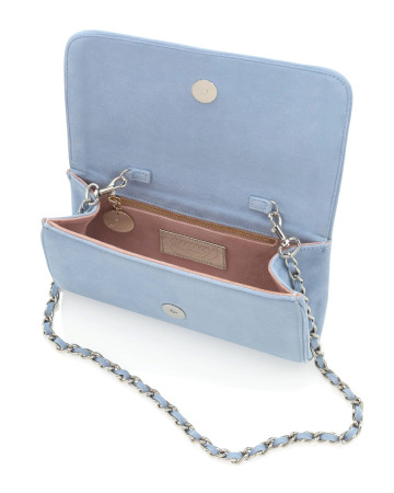 Close-up of the Emmy London Natasha clutch in Power Blue suede, showing its structured flap-front design and soft suede texture.
