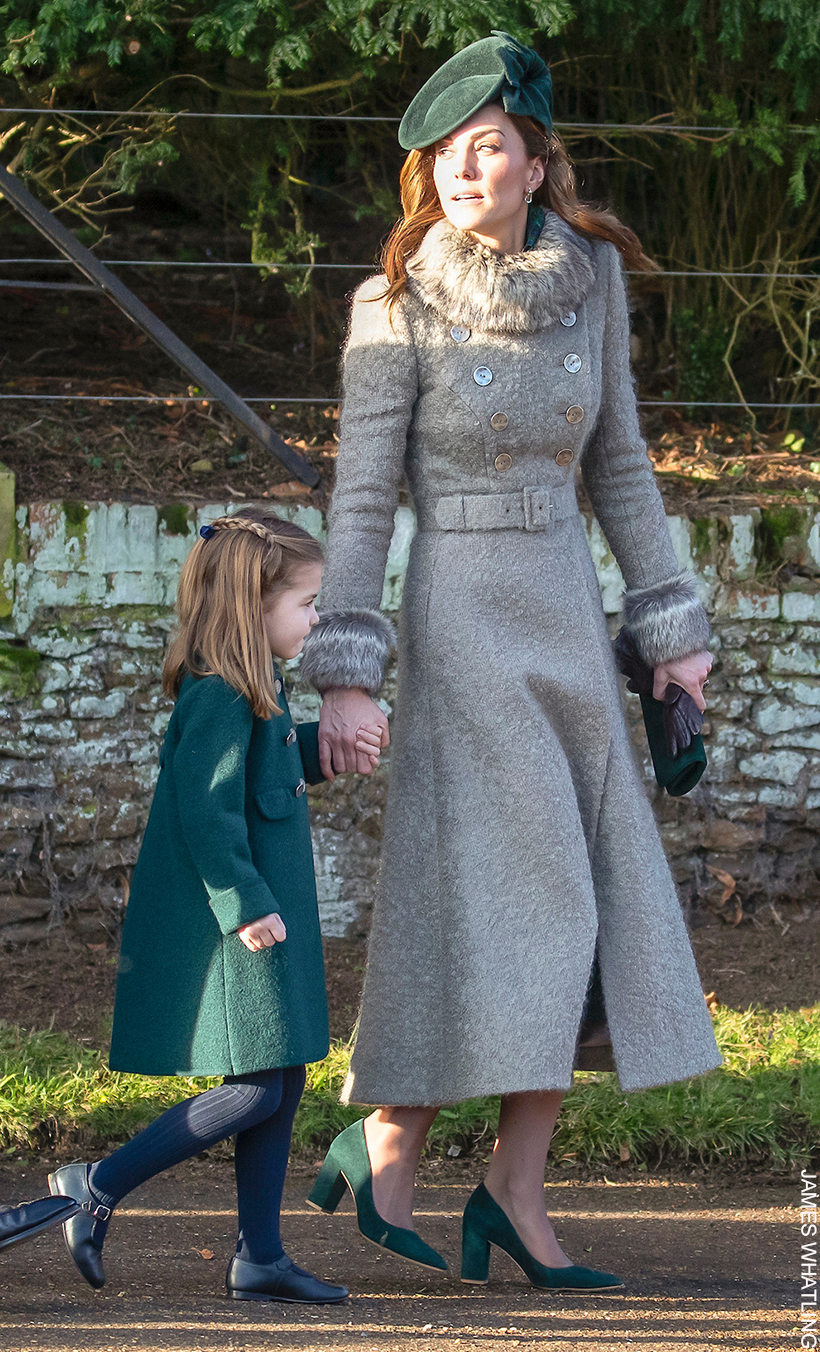 Kate Middleton walking with Princess Charlotte on Christmas Day in 2019. The Princess wears a winter coat in grey with her green block heel pumps.