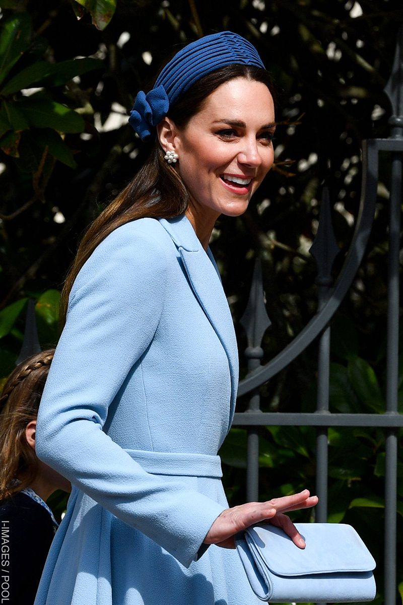 Kate Middleton carrying the Emmy London Natasha clutch in duck egg blue suede at the 2022 Easter Sunday service, paired with a matching coat dress and blue headband.