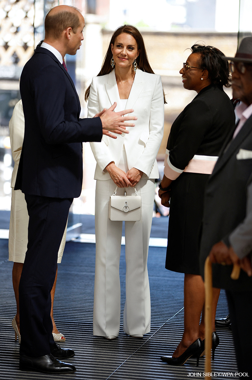 Kate Middleton holding the white handbag on Windrush Day. The Princess opted for an all-white look