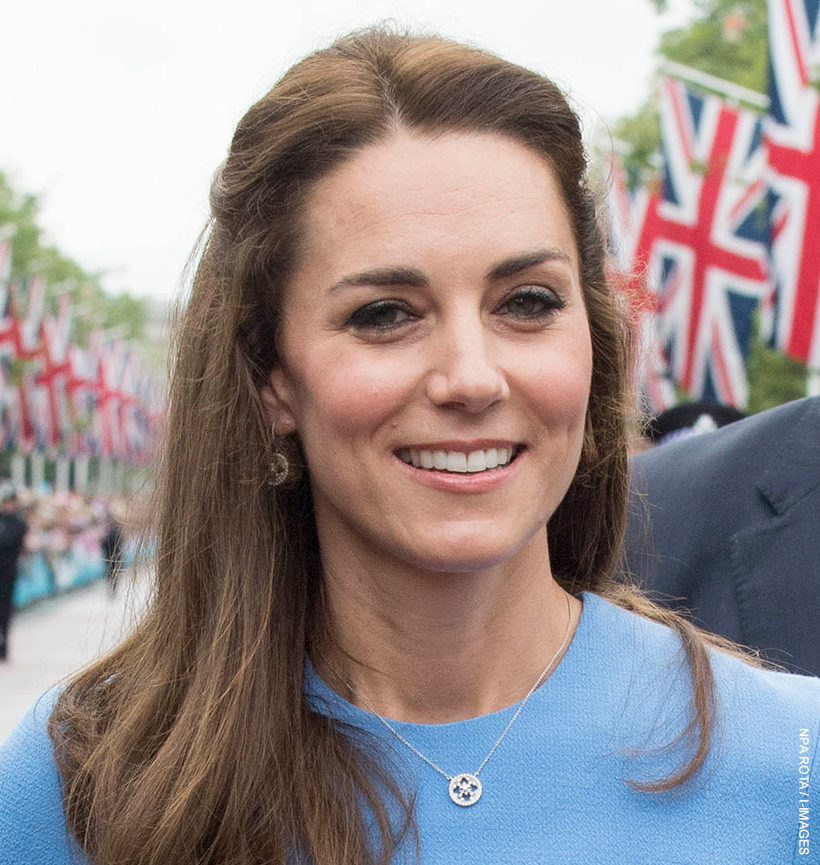 Princess of Wales stood on The Mall wearing the Empress necklace by Mappin & Webb over a blue dress.