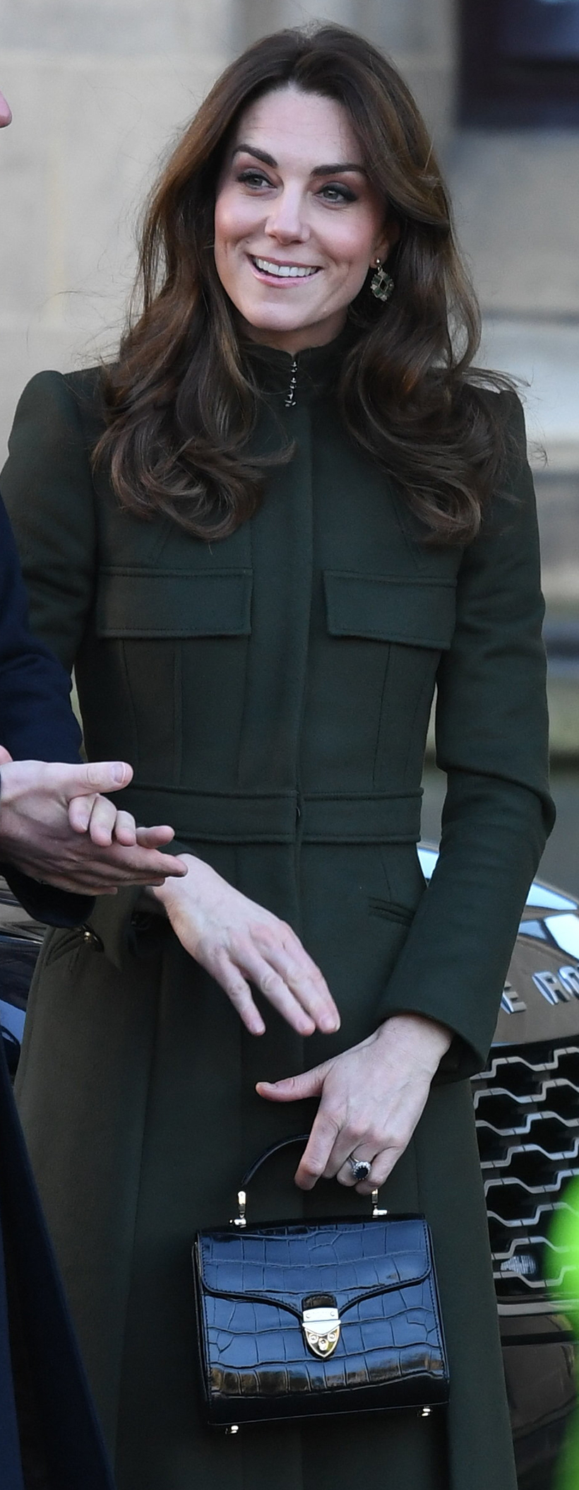 The Princess of Wales (Kate Middleton) wearing a dark green coat carrying a black croc bag—it's the Aspinal of London Mayfair Midi bag