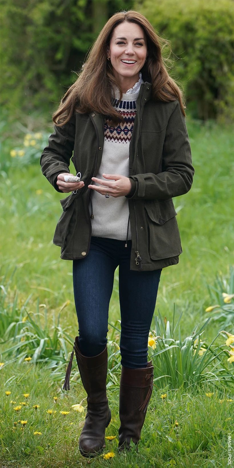Kate Middleton wearing the Brora sweater during a farm visit.