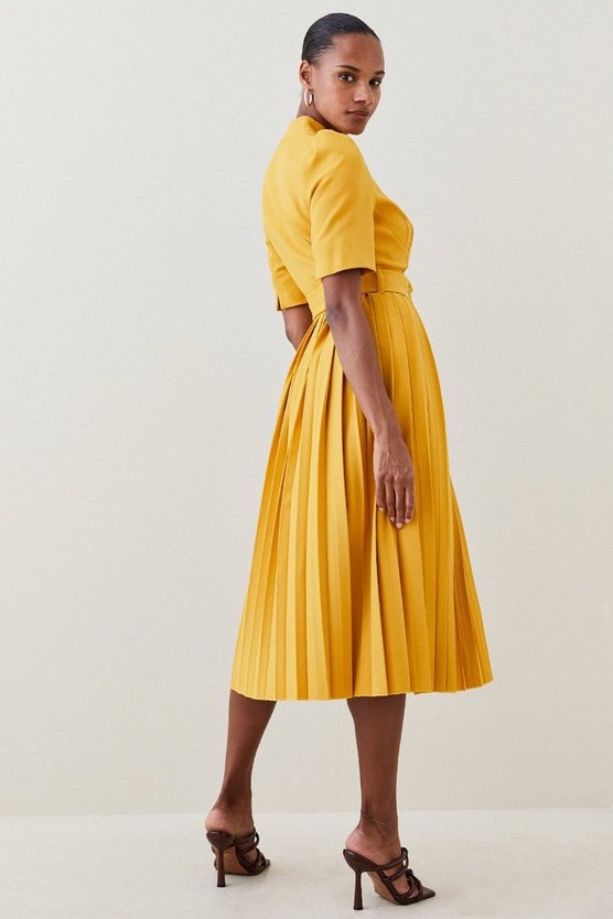 Model wearing the yellow pleated "Forever" dress by Karen Millen - back view