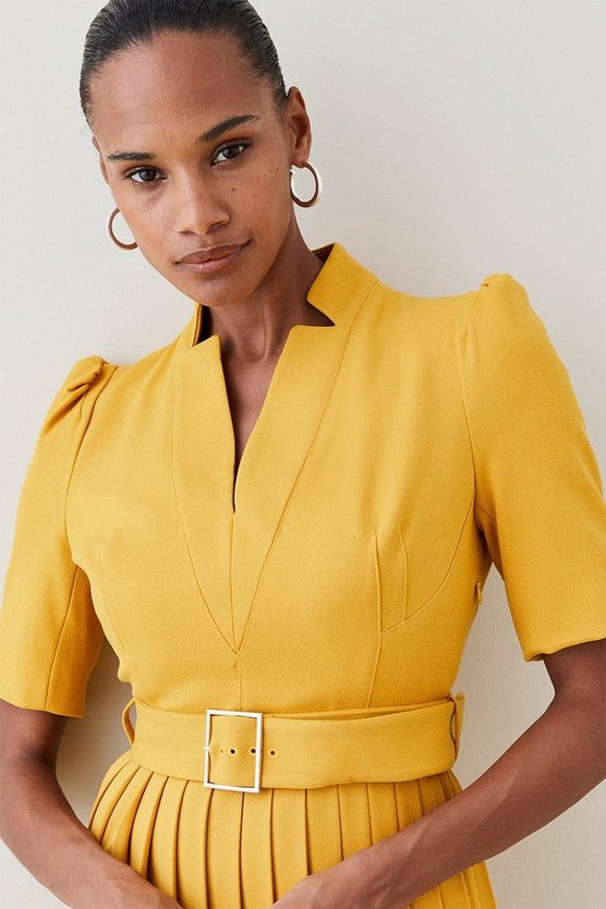 Model wearing the yellow pleated "Forever" dress by Karen Millen - close up bodice view