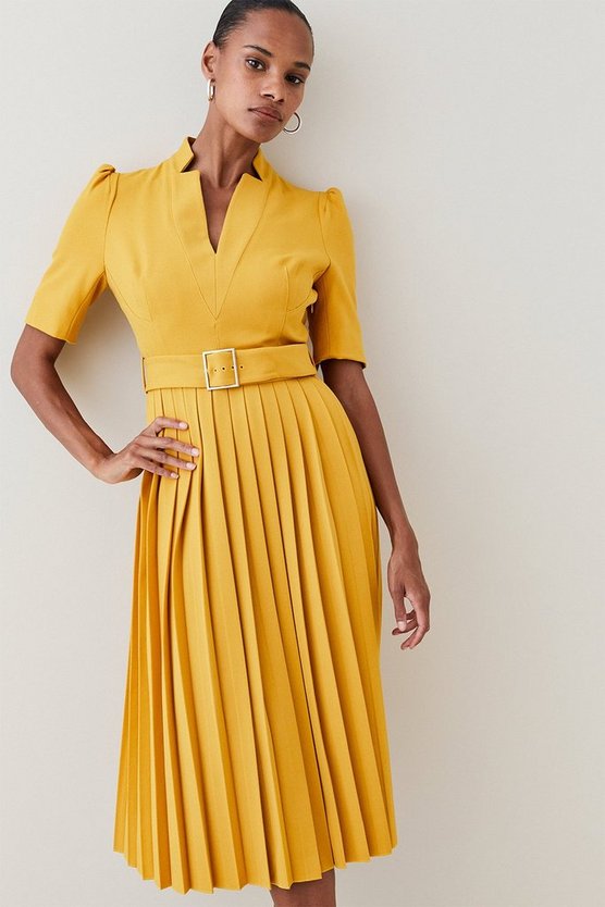 Model wearing the yellow pleated "Forever" dress by Karen Millen - back view