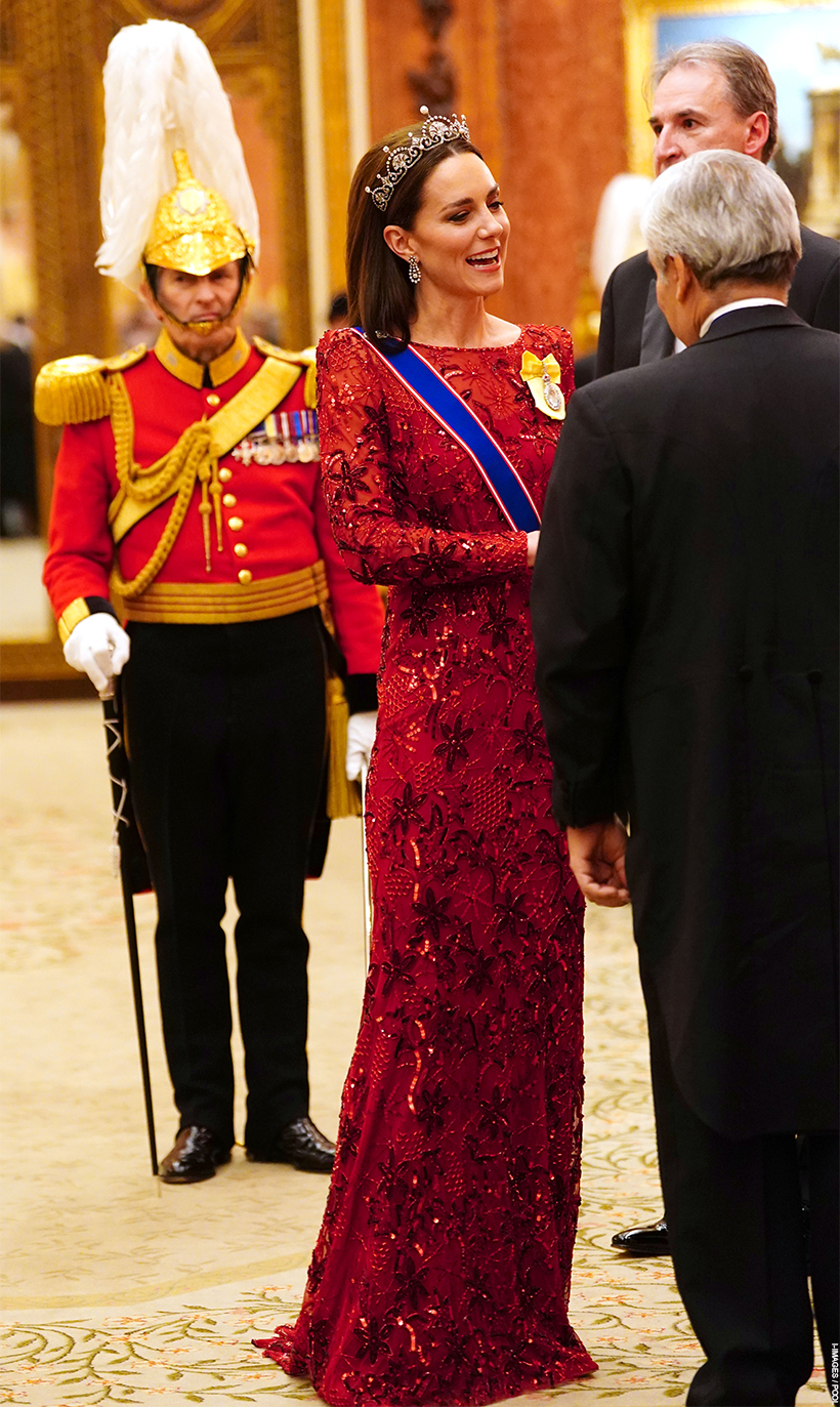 The Princess of Wales stood chatting to a guest at the 2022 Diplomatic Reception. Kate wears a floor-sweeping red glittering gown and the Lotus Flower Tiara.