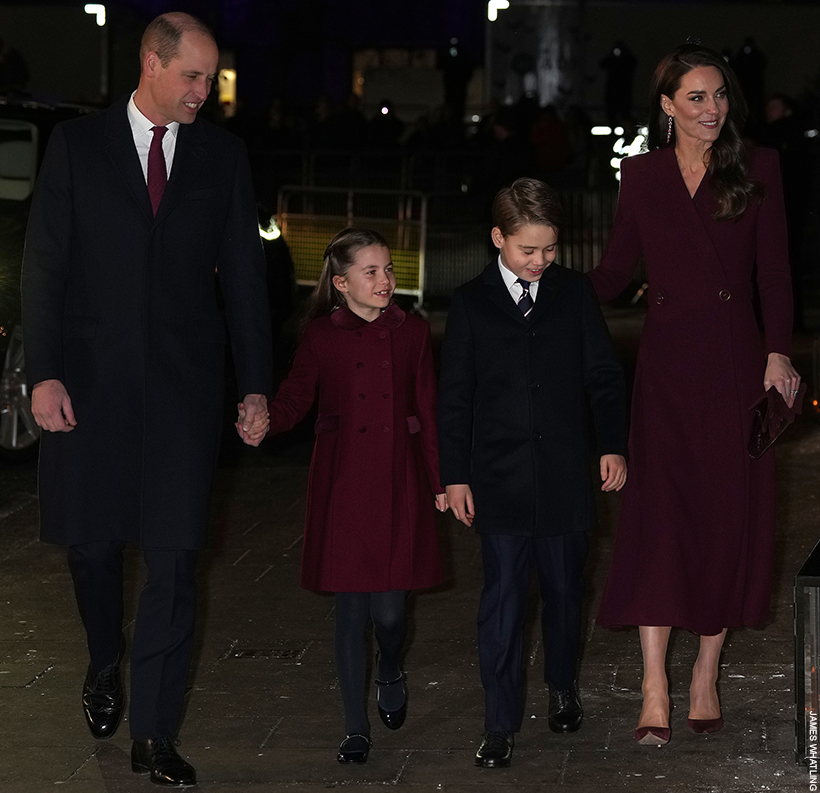 The Wales Family - William, Kate, George, Charlotte and Louis - walking onto the 2022 'Together At Christmas' carol concert, wearing coordinating burgundy outfits.