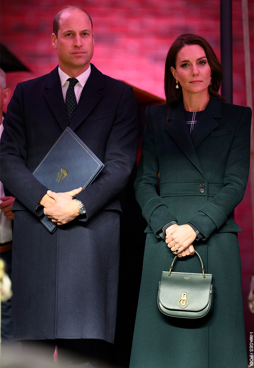 Kate Middleton stood with Prince William.  Kate is holding the Mulberry Amberley Satchel in her hand