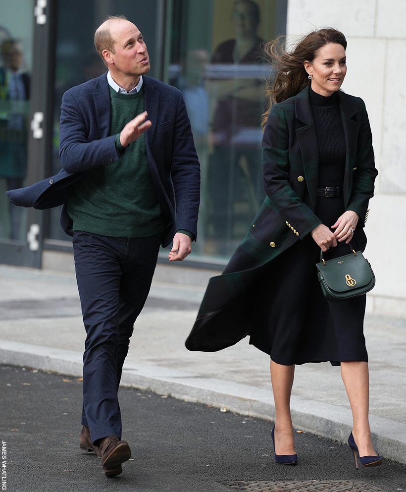 William and Kate walking together.  Kate is holding the green Amberley satchel in her hand.