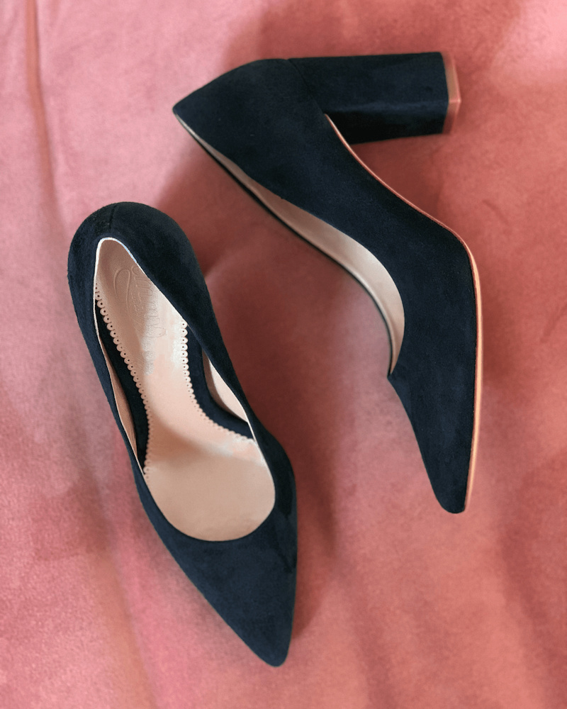 Emmy London Josie Block Heel Pumps in Midnight Navy Blue, shown on a pink background