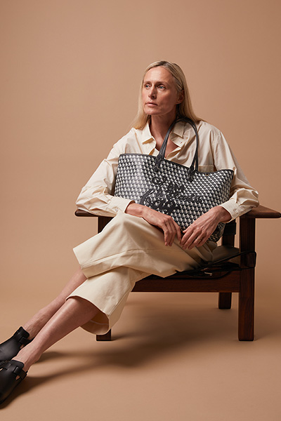 Model holding an Anya Hindmarch handbag