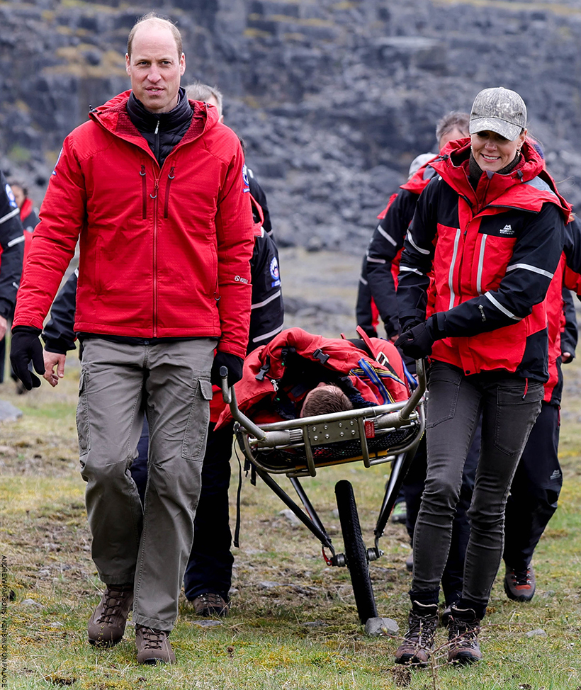 William and Kate take part in a mountain rescue training session in Wales.  The pair are trying to move a person pretending to be injured. 