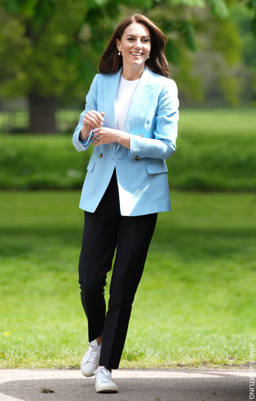 Kate Middleton at The Big Lunch on the long walk in Windsor, wearing a baby blue blazer with trousers and trainers.  A casual-chic look.