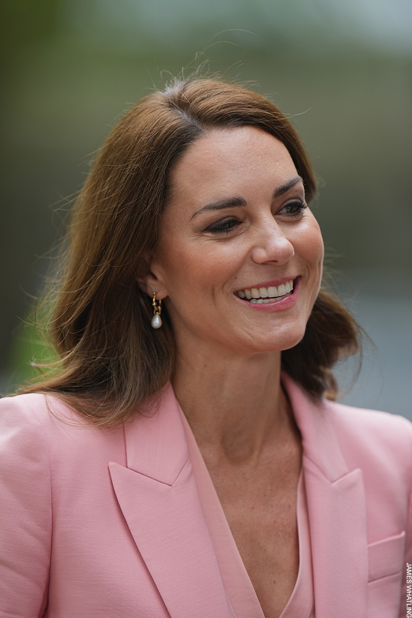 Kate Middleton wearing pearl earrings with her pink suit