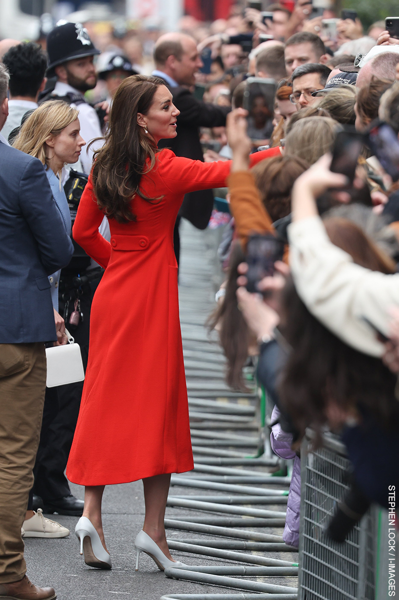 Kate Middleton meeting people in the crowd that'd assembled near to a pub in Soho.  She's wearing the white Jimmy Choo pumps.
