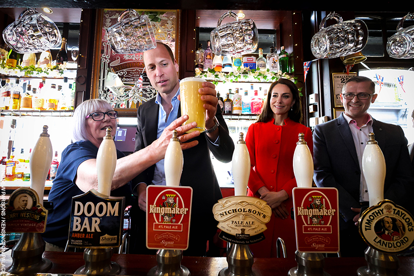 William behind the bar, the Prince pulls a pint in the pub