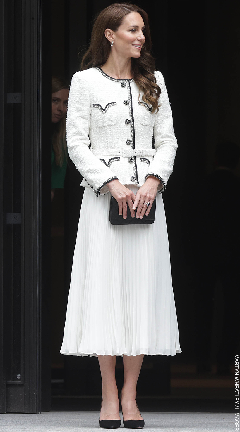 Kate Middleton wearing a white Self Portrait dress, carrying a Chanel clutch and wearing black slingbacks from Aquazzura at the National Portrait Gallery today